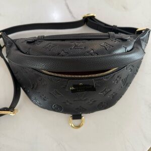 Black embossed crossbody bag, gold hardware, leather.